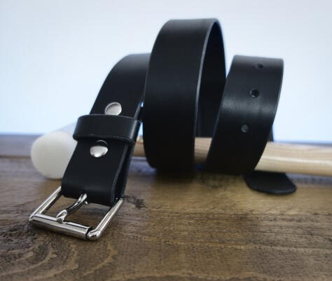 Classic Black Full Grain Leather Belt Thumbnail image of the classic collection black full grain lamport italian leather belt, curled up around a leather work hammer with silver colour hardware.